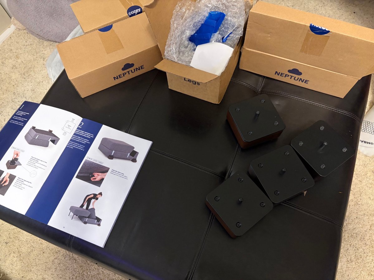 Unboxing the Cozey Neptune Sleeper Sofa next to the instruction manual