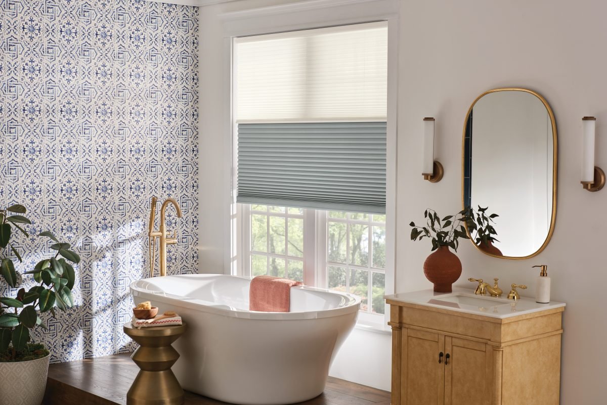 Blue and white decorated bathroom with blue cellular shades