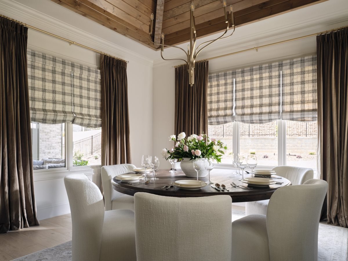 Dining room with Tailored Roman Shades and Drapery