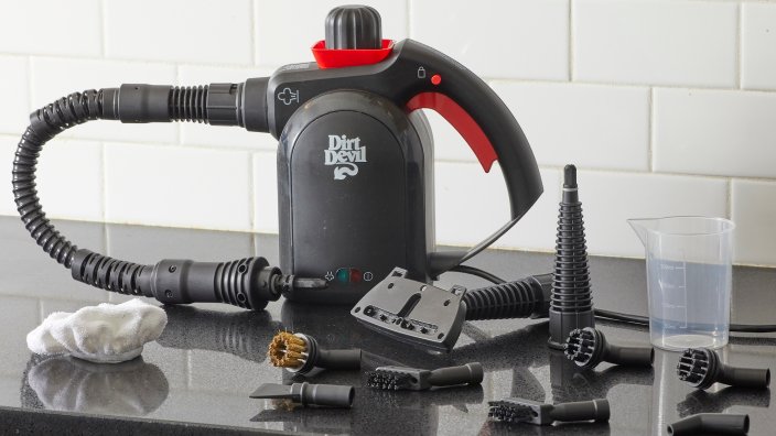 Dirt Devil steam cleaner on a kitchen countertop surrounded by its various attachments.