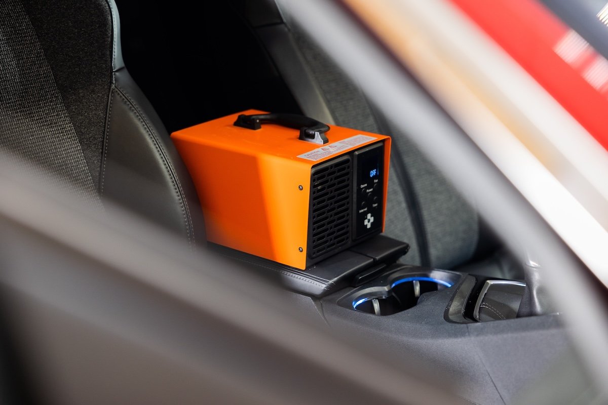 An orange ozone machine in a car.