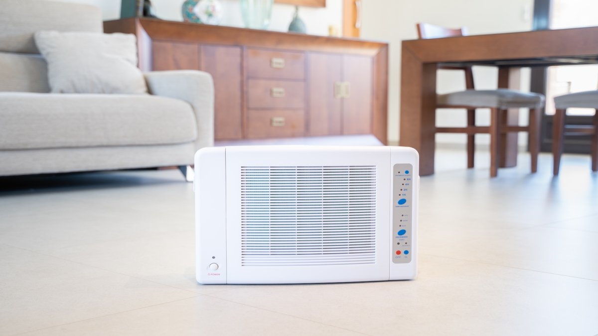 A while ozone machine sits in a living room.
