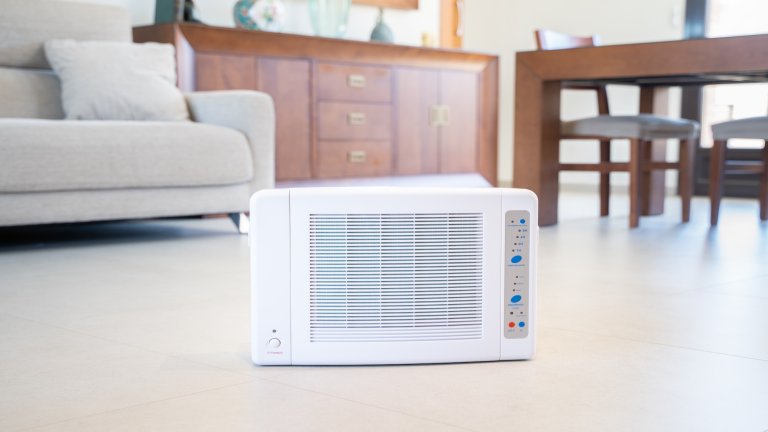 A while ozone machine sits in a living room.