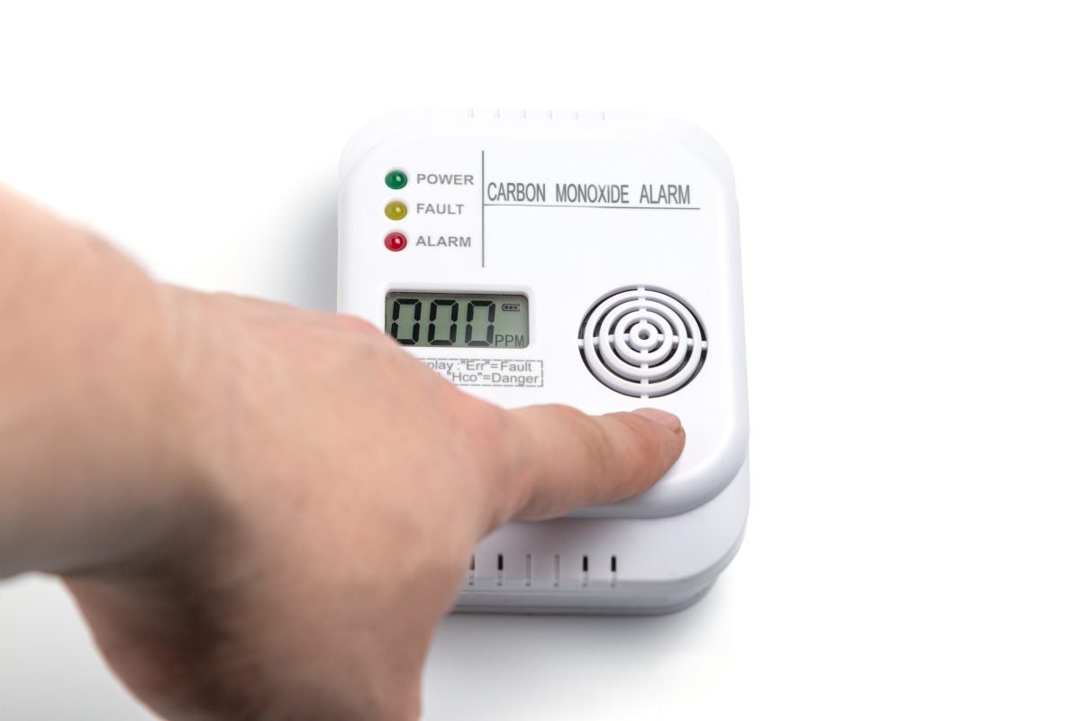Person testing a carbon monoxide detector.