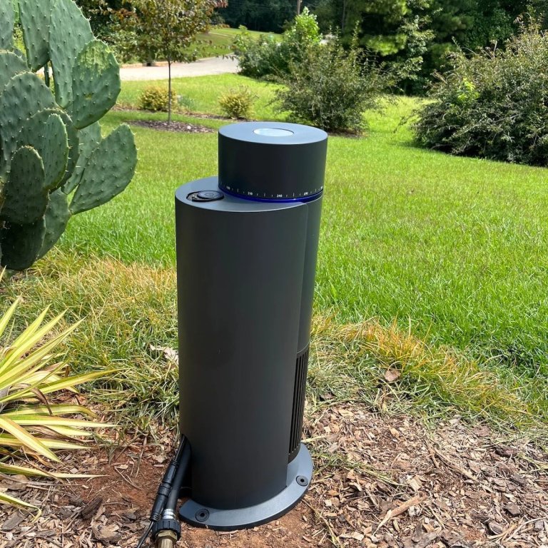 The Aiper IrriSense 2 Smart Irrigation System in a yard during testing