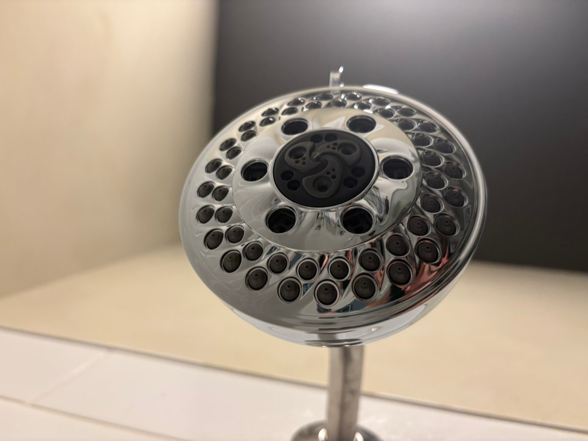 Delta H20kinetic 5-Setting Shower Head in the bathroom as an example of the best shower head for low pressure