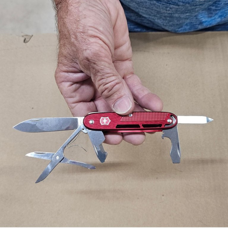 A product tester showing each tool in the Victorinox Synergy X Alox during testing