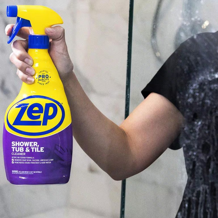 DIYer holding a bottle of Zep shower cleaner.