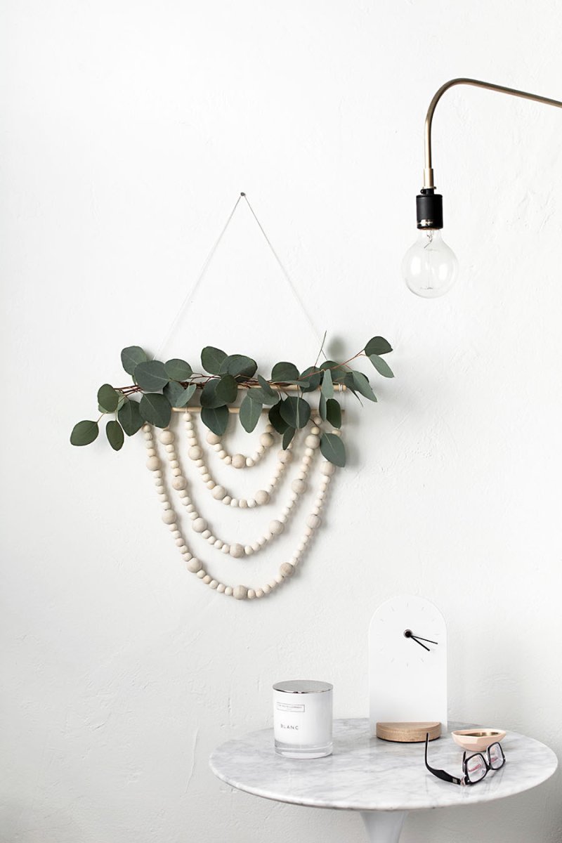 Modern, sleek white wall decor with fall flowers on top.