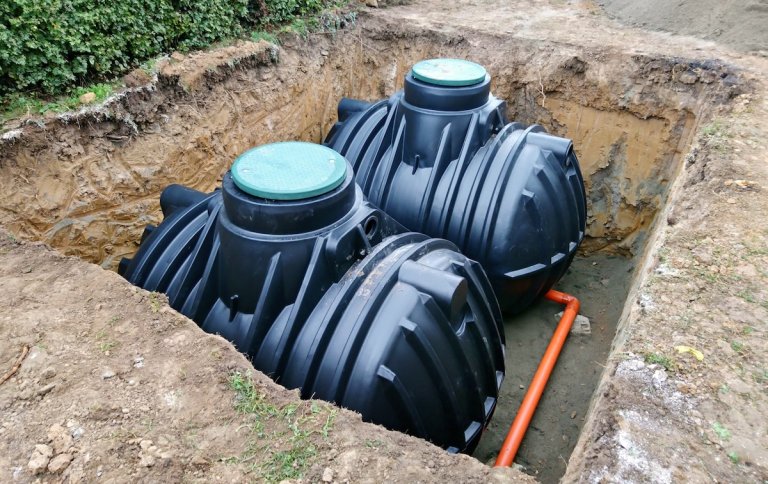 Two underground rain barrels create a dry well system.