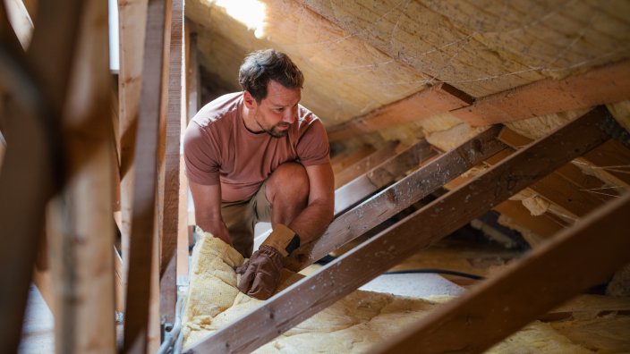 DIY homeowner working on energy efficient home renovation.