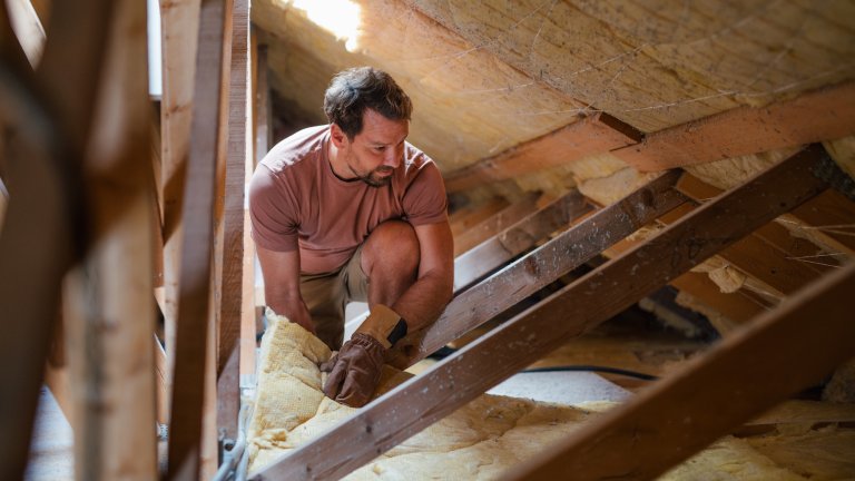 DIY homeowner working on energy efficient home renovation.