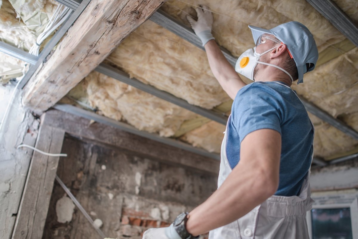 Contractor replaces old mineral wool Insulation. 