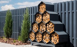 Stylish decorative firewood rack with cells in the form of honeycombs