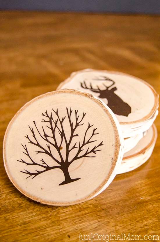 Sliced rounds of wood are stenciled with fall motifs and used as coasters.