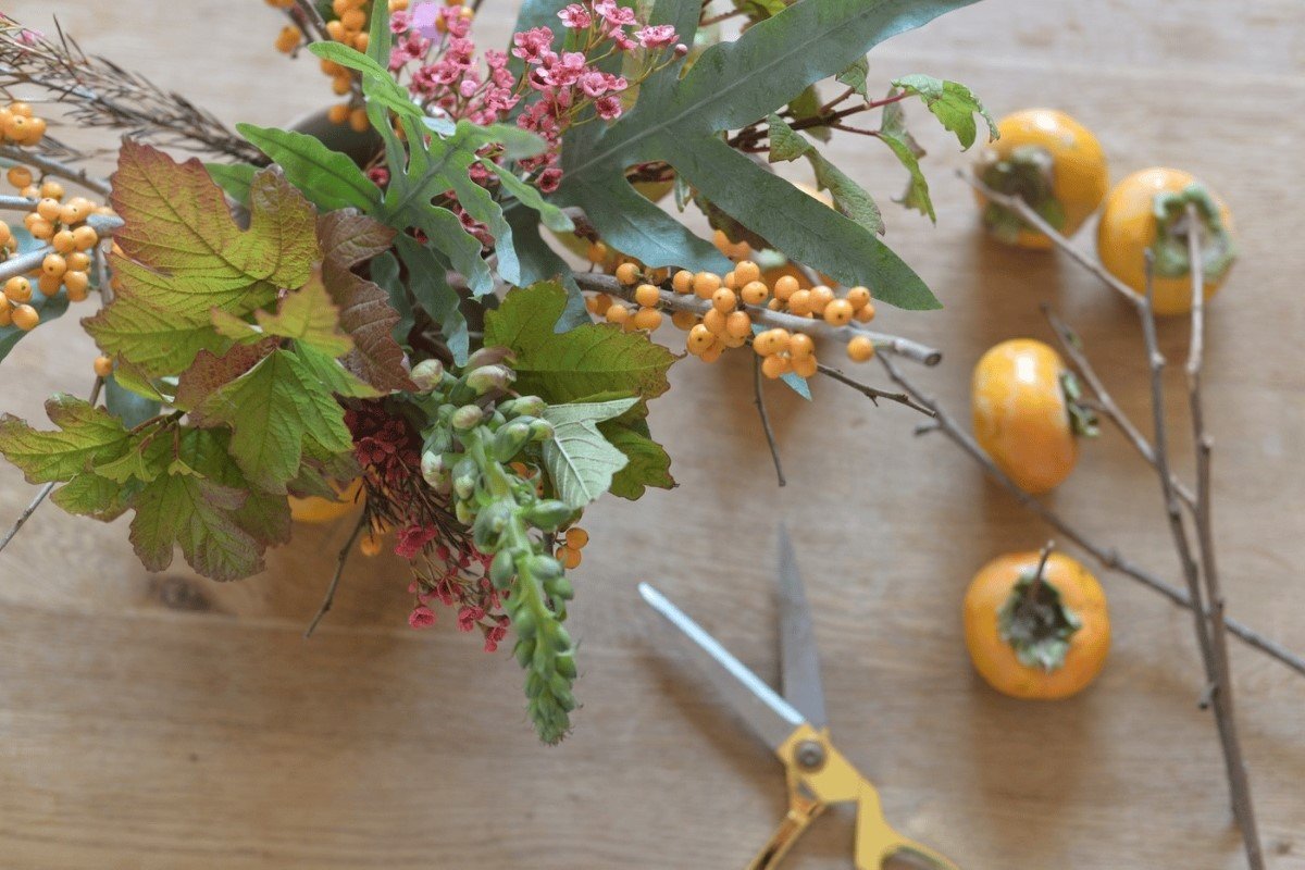 Persimmons used for a floral arrangement.