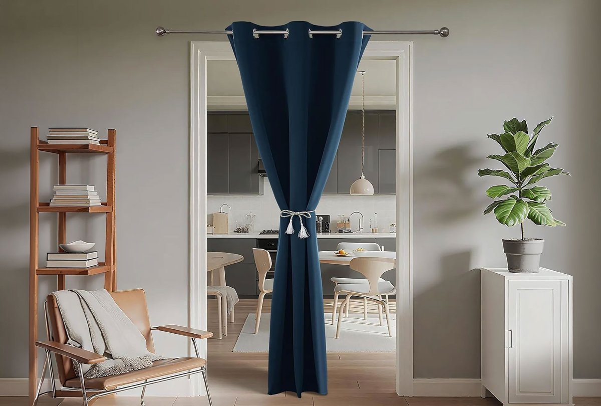 A blue curtain mounted between a kitchen and living room to create more divided spaces.