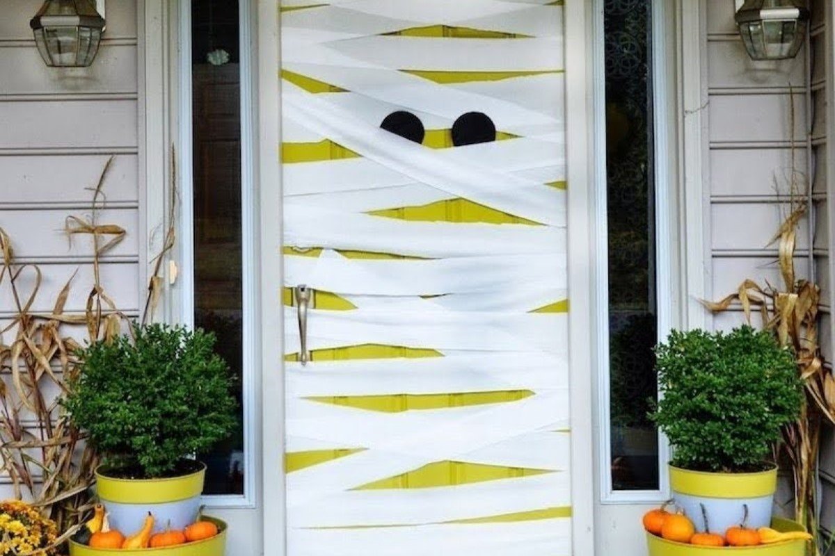 The front door in the home is decorated as a mummy with eyes.
