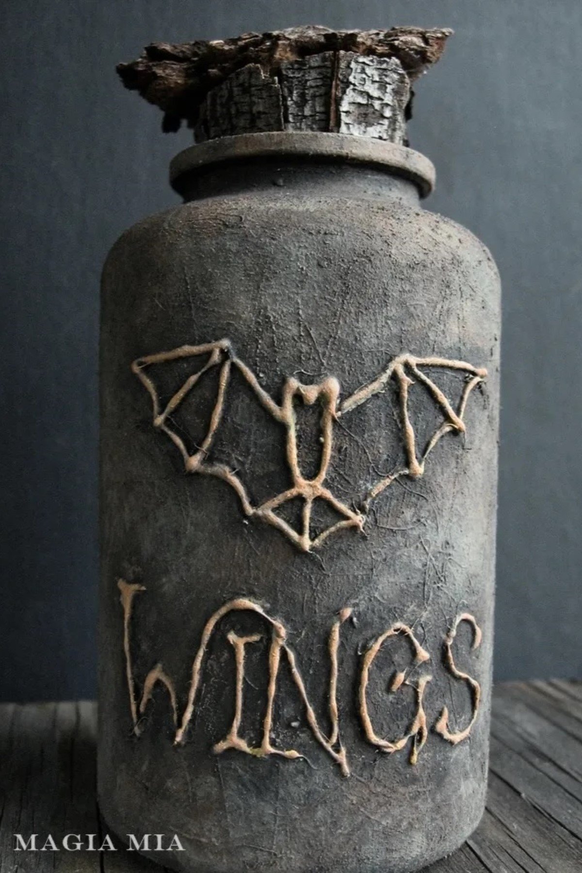 DIY plastic medicine bottle decorated with a bat.