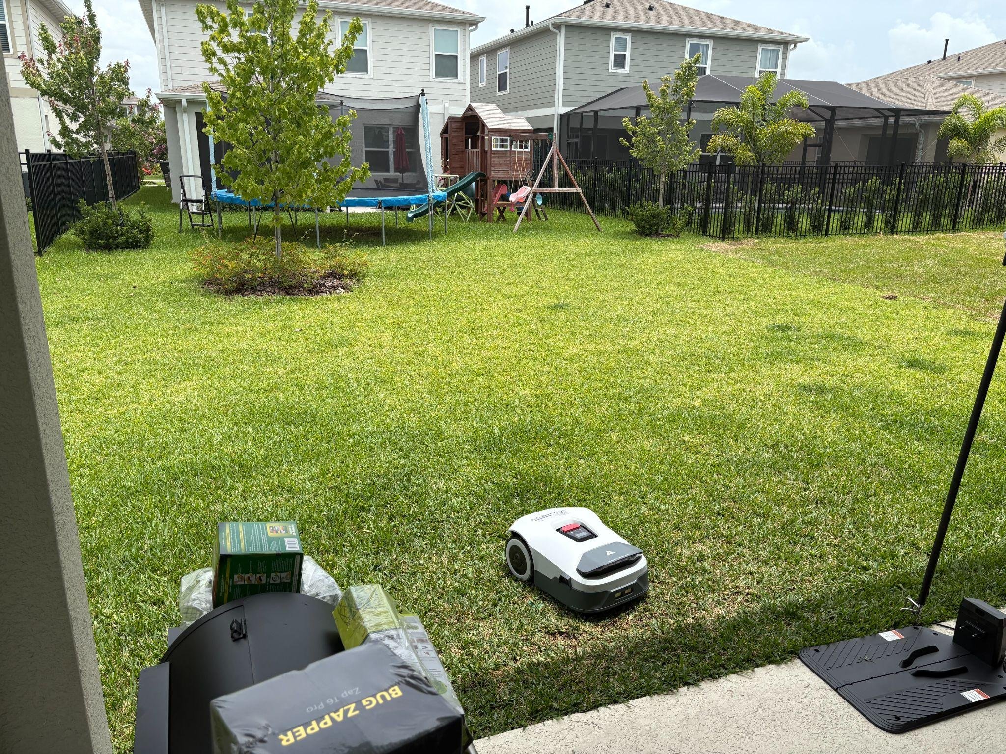 Robotic lawn mower on a backyard lawn