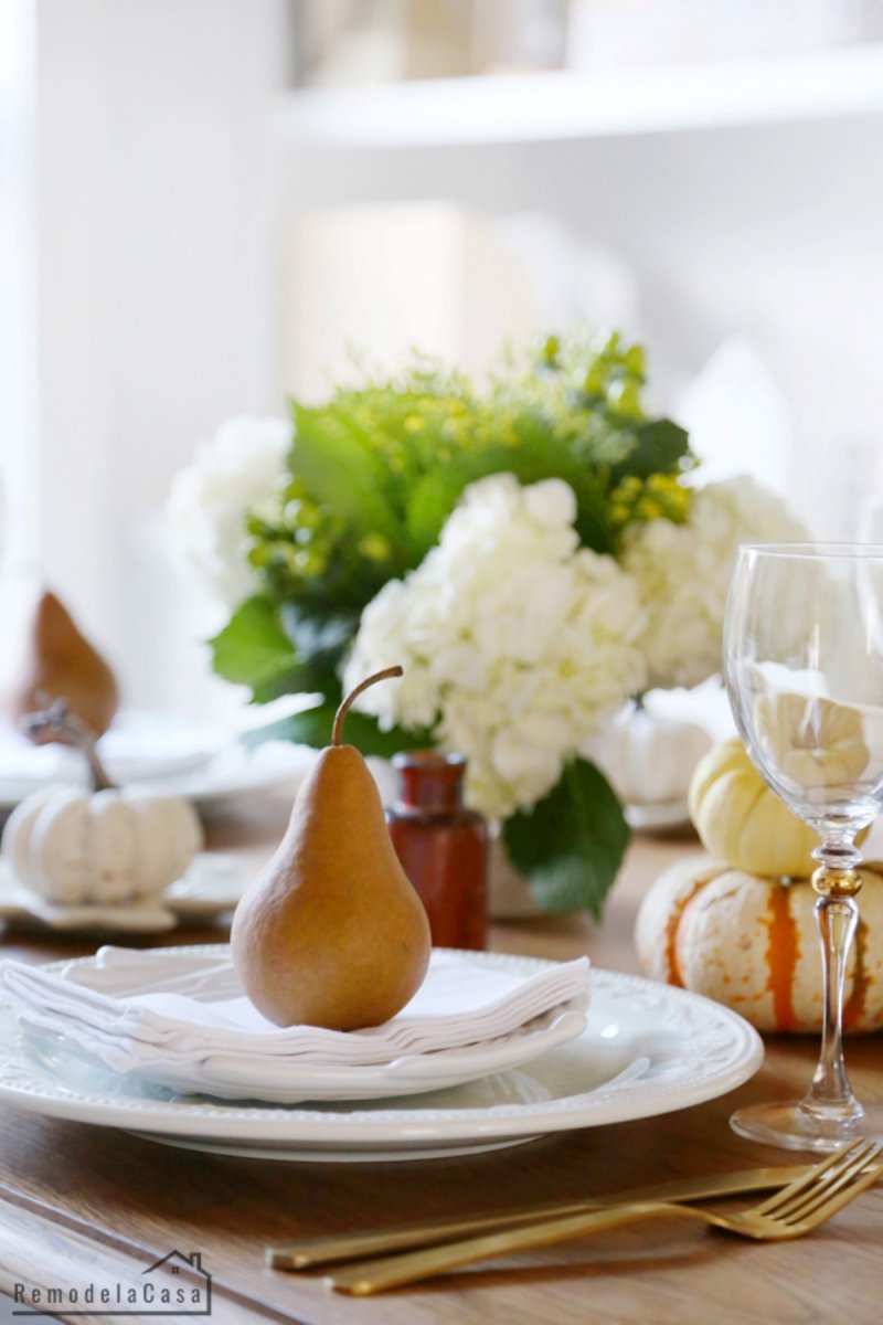 A pear is placed on top of the guest place setting.