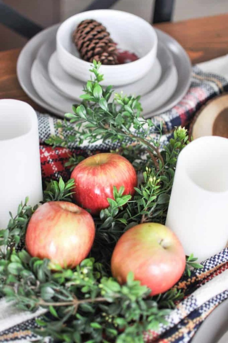 Apples used to decorate the table runner at the dinner table.