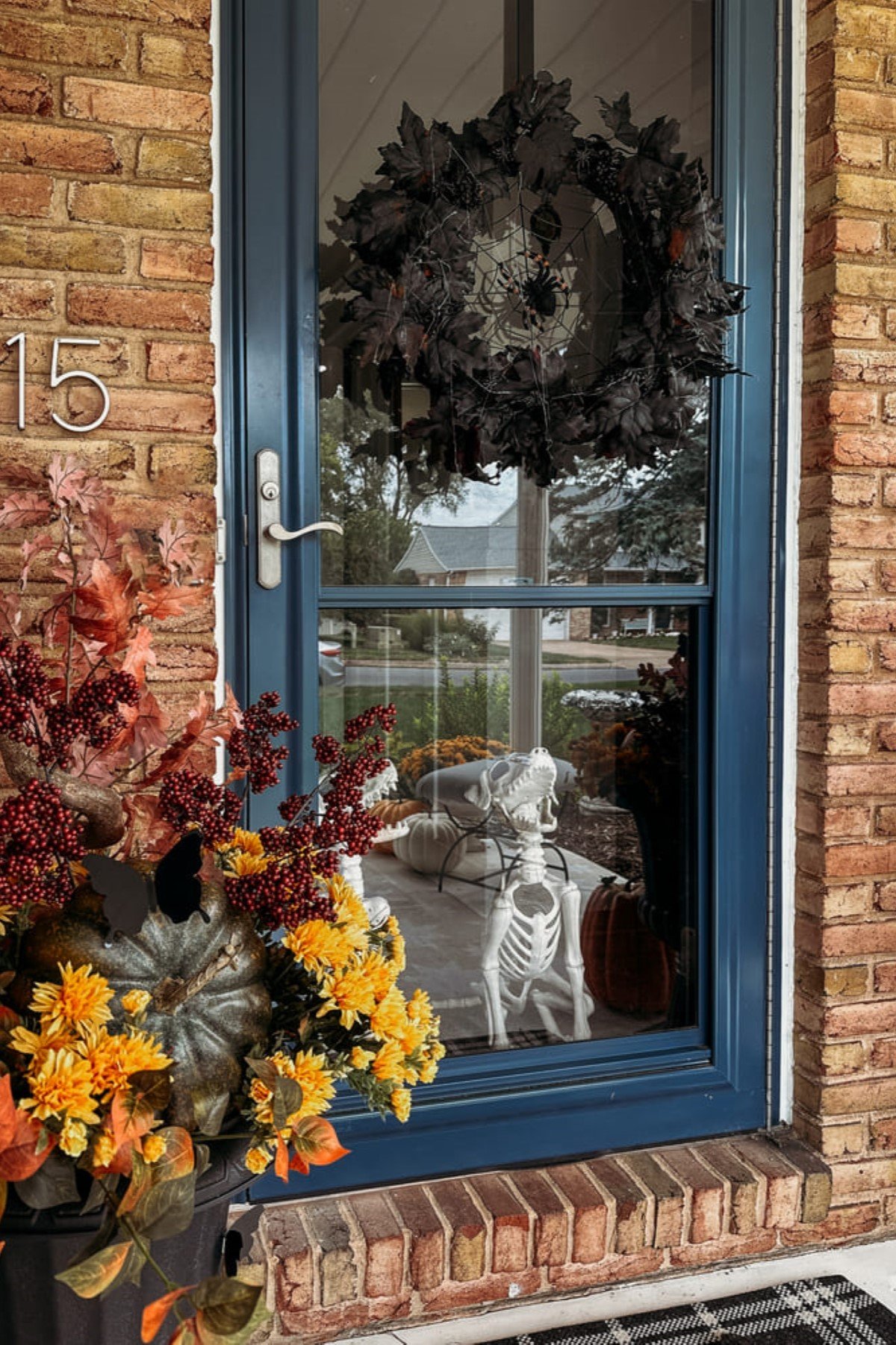 A black Halloween wreath is hanging on the front door.